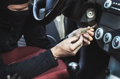 thief opening a car