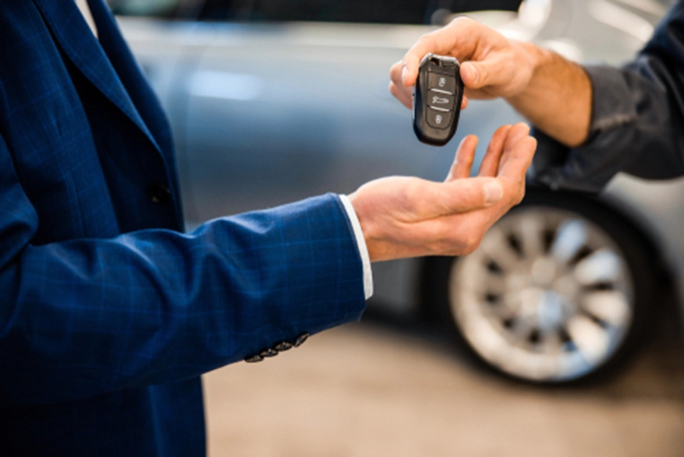 a man giving a new key to another person